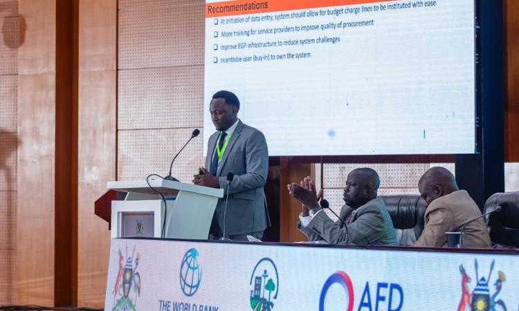 GKMA-UDP Coordinator for Mpigi delivering a presentation on valuing and tracking in-kind and community contributions and, addressing procurement and eGP challenges at the GKMA-UDP Midterm Review.